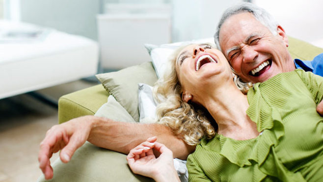 Laughing Seniors on Couch